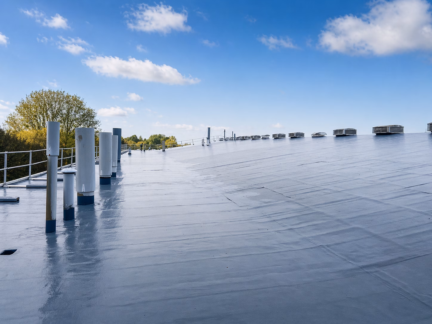 Liquid Roof Refurbishment – Completed Flat Roof System Completed liquid roof system on a commercial building with roof outlets and flat roof finish