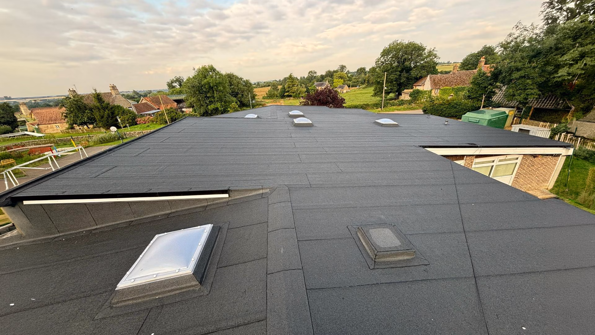 professional lat felt rooftop installation over a large surface.