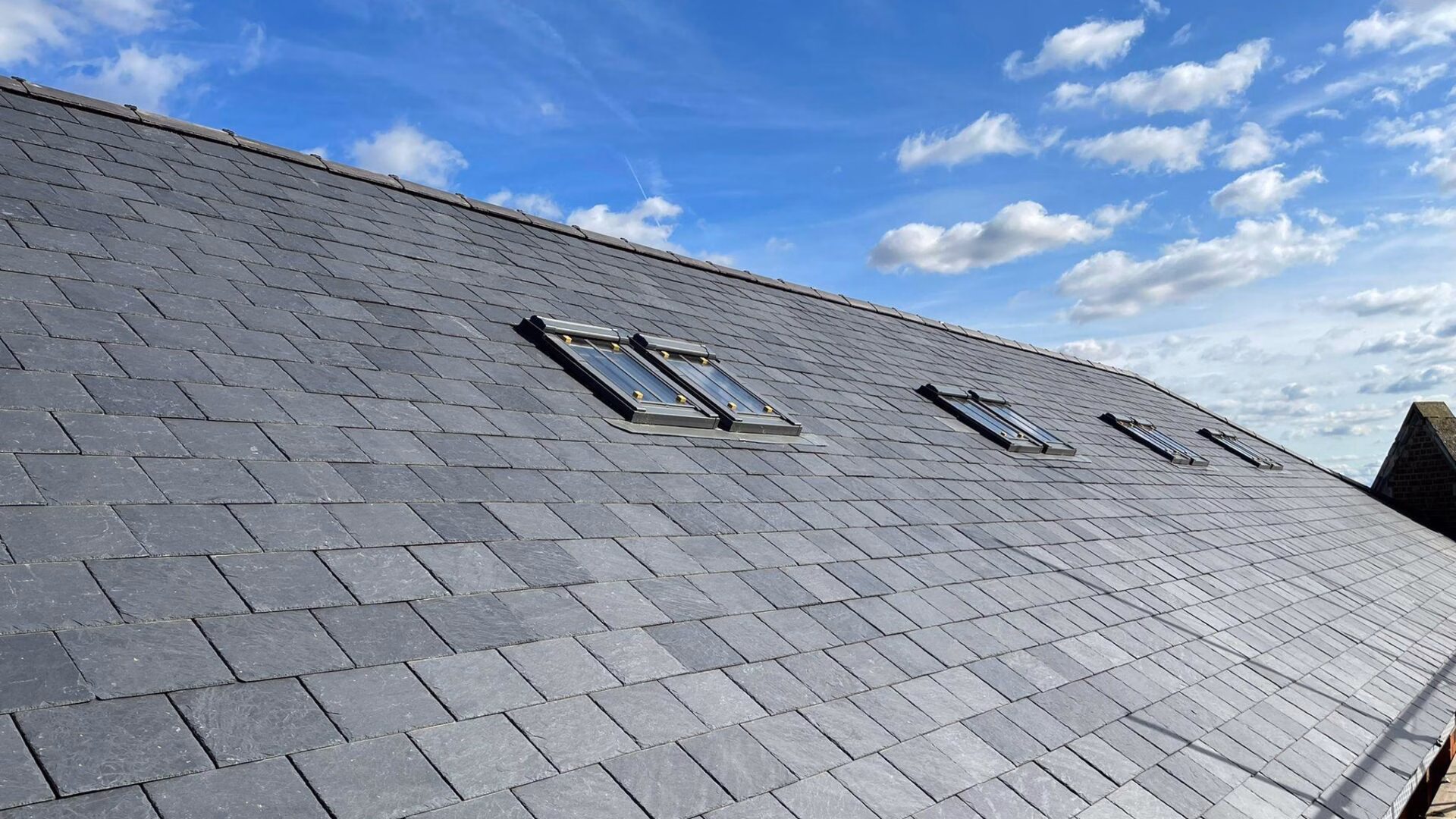 tiled-roofing-installation-with-glass-windows Tiles roofing installation with glass windows.