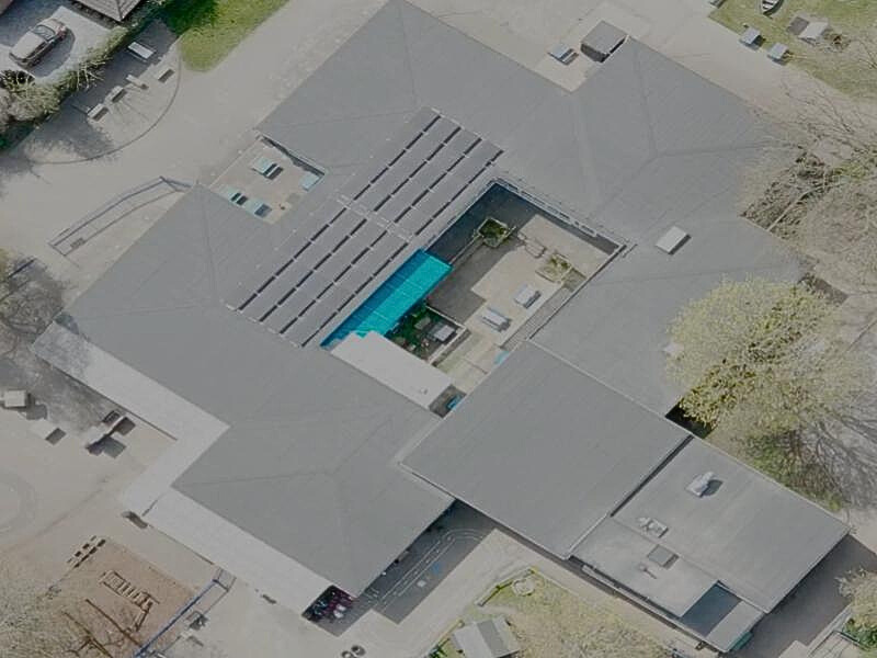 Aerial view of St Andrews School showing newly installed flat roof system and solar panels surrounding the central courtyard.