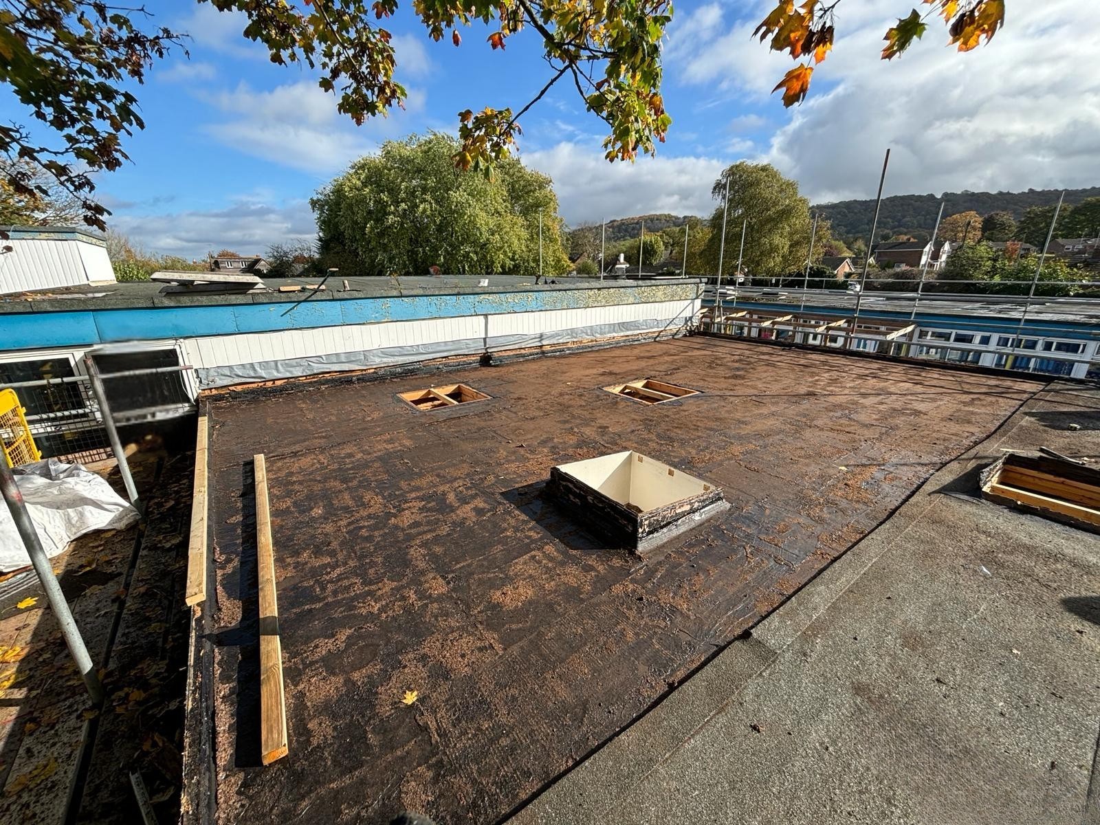 Flat roof refurbishment works in progress at St Andrews School in Oxfordshire showing stripped roof surface and preparation stage prior to new roofing installation.