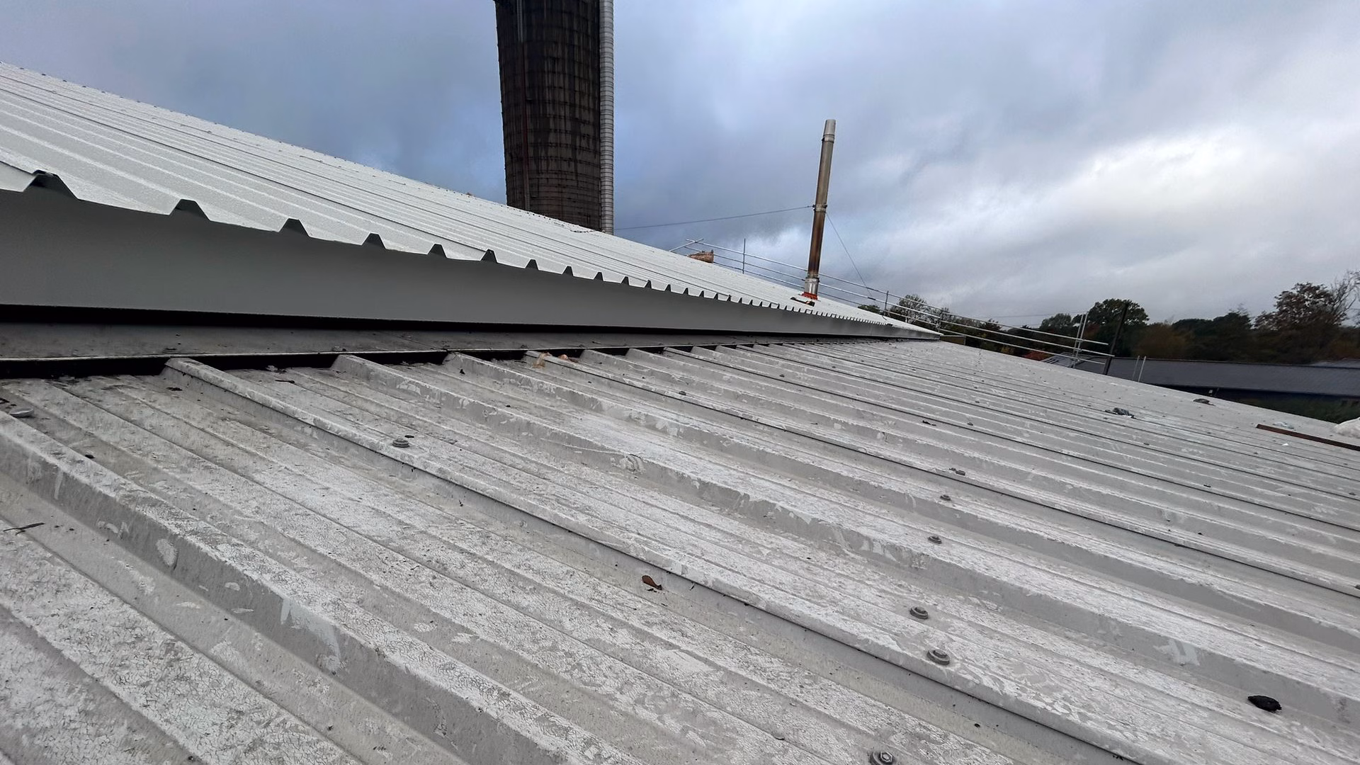Existing ageing roof coverings at Staplehurst Farm prior to encapsulation and overcladding works.