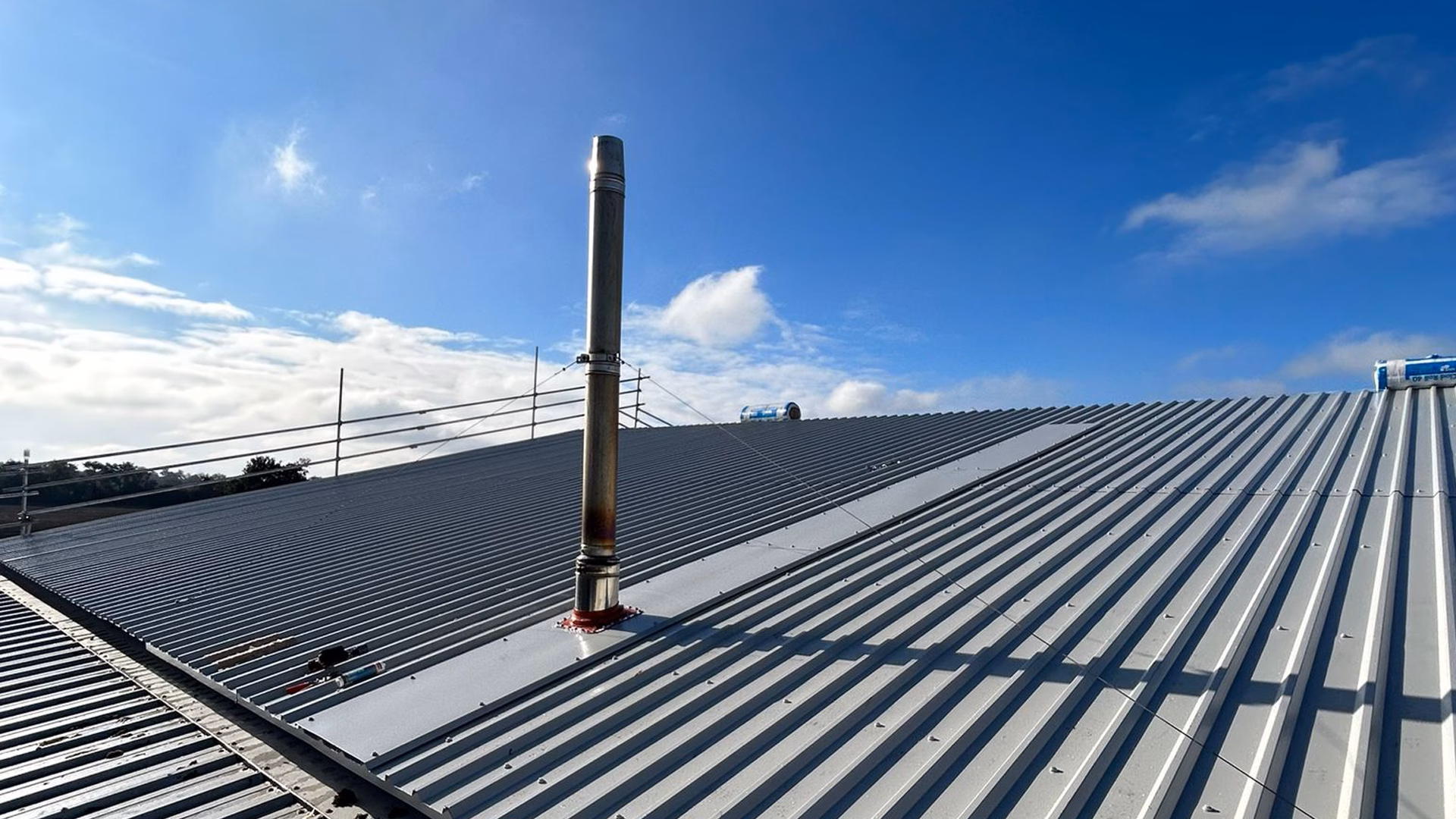 New metal roof overcladding installed over the existing roof structure at Staplehurst Farm.