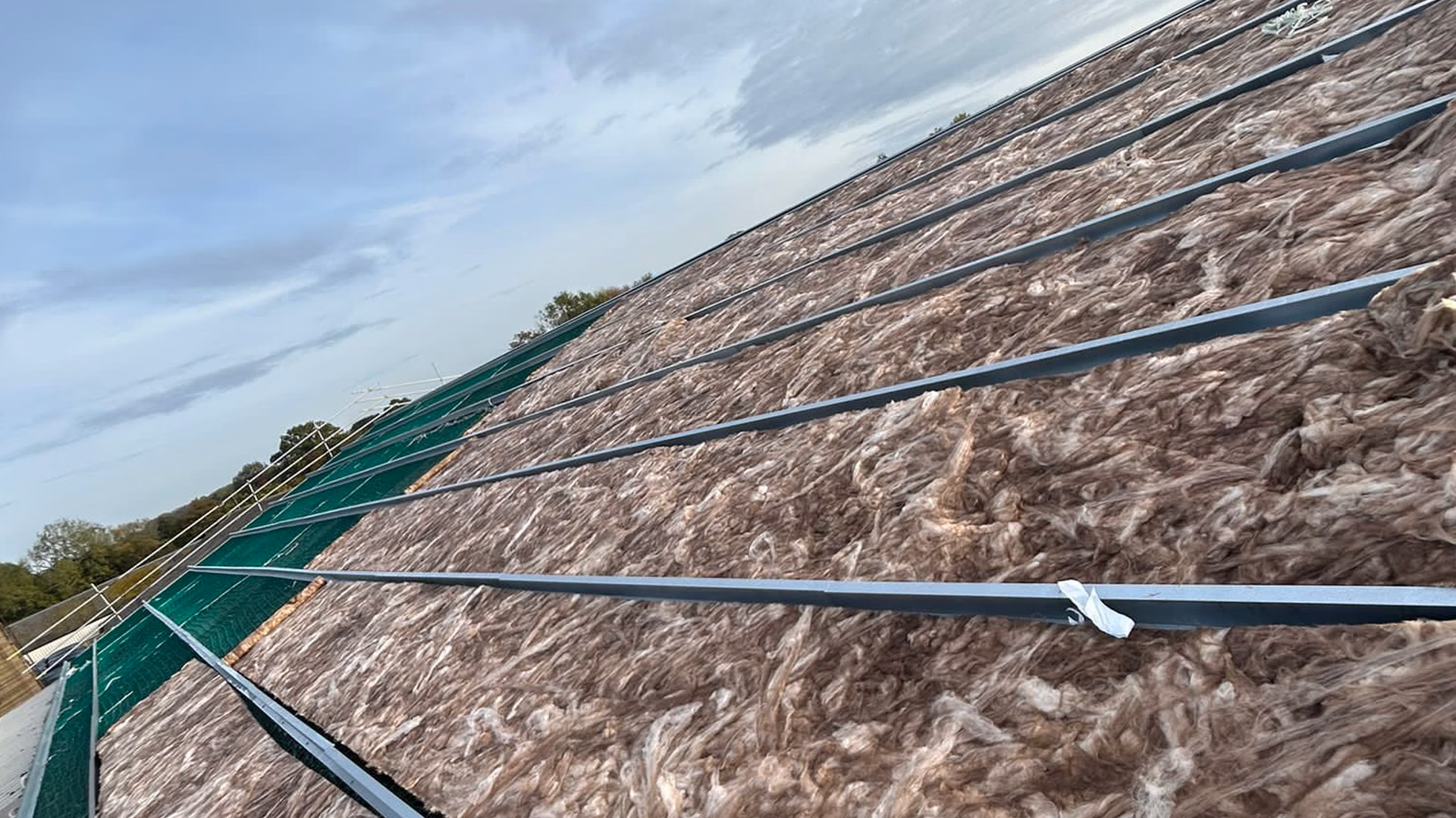 Roof insulation installed between rails at Staplehurst Farm as part of a commercial roof overcladding project.