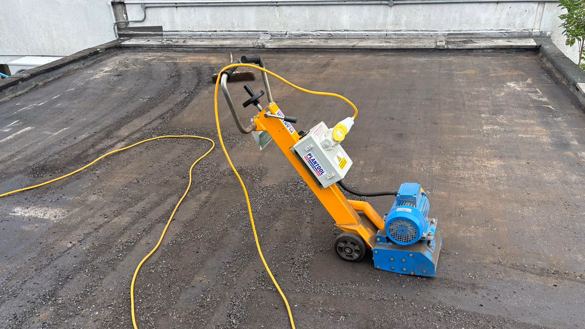 Mechanical preparation of the existing flat roof at Eddisons - Riley Square prior to installation of the new overlay system.