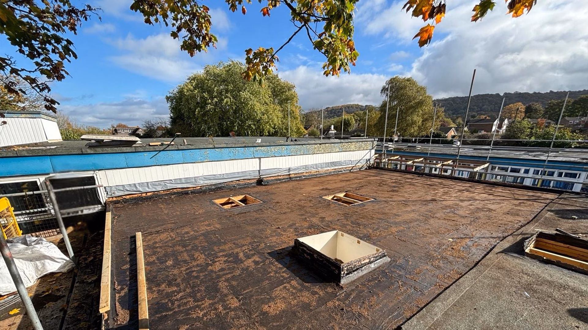 Flat roof refurbishment works in progress at St Andrews School in Oxfordshire showing stripped roof surface and preparation stage prior to new roofing installation.